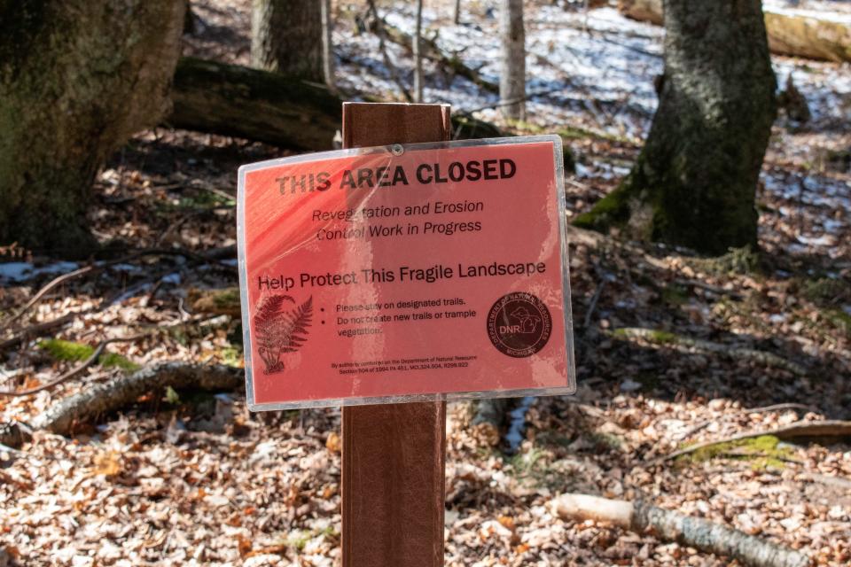 A sign in Porcupine Mountain Wilderness State Park in March 2024 shows an area of the park closed off due to erosion. The area where the Copperwood Mine will be is known for its eroding shoreline. Environmentalists worry that erosion and the increased frequency and intensity of storms from climate change may increase the risks of mining near Lake Superior.