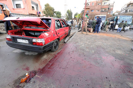 Blood stains the ground as people inspect the damage at the site of an attack by two suicide bombers in Damascus, Syria March 11, 2017. REUTERS/Omar Sanadiki