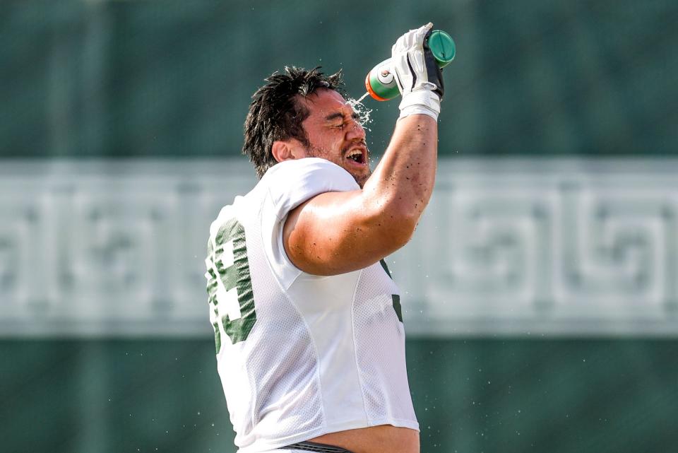 Michigan State defensive lineman Jalen Sami cools off during football practice on Wednesday, Aug. 9, 2023, in East Lansing.