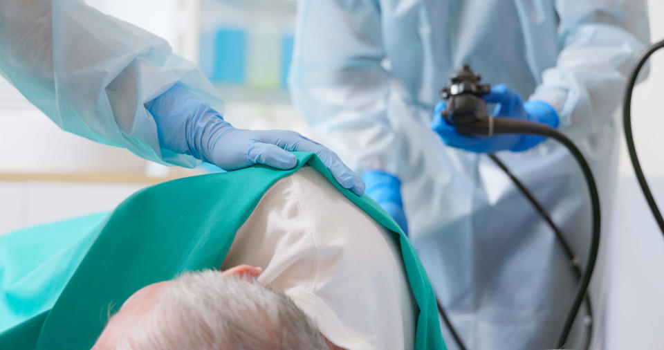 Medical professional using equipment on patient's head