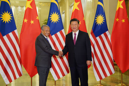 Chinese President Xi Jinping shakes hands with Malaysian Prime Minister Mahathir Mohamad before the bilateral meeting of the Second Belt and Road Forum at the Great Hall of the People in Beijing, China, April 25, 2019. Andrea Verdelli/Pool via REUTERS