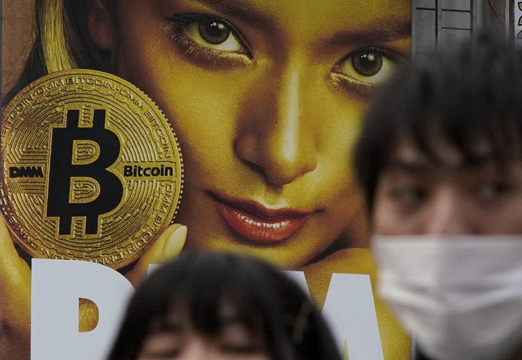 <span class="caption">In this February 2018 photo, a huge advertisement of Bitcoin is displayed near Shibuya train station in Tokyo. Bitcoin has been a legal form of payment in Japan since April 2017.</span><br> <span class="attribution"><span class="source">(AP Photo/Shizuo Kambayashi)</span></span>