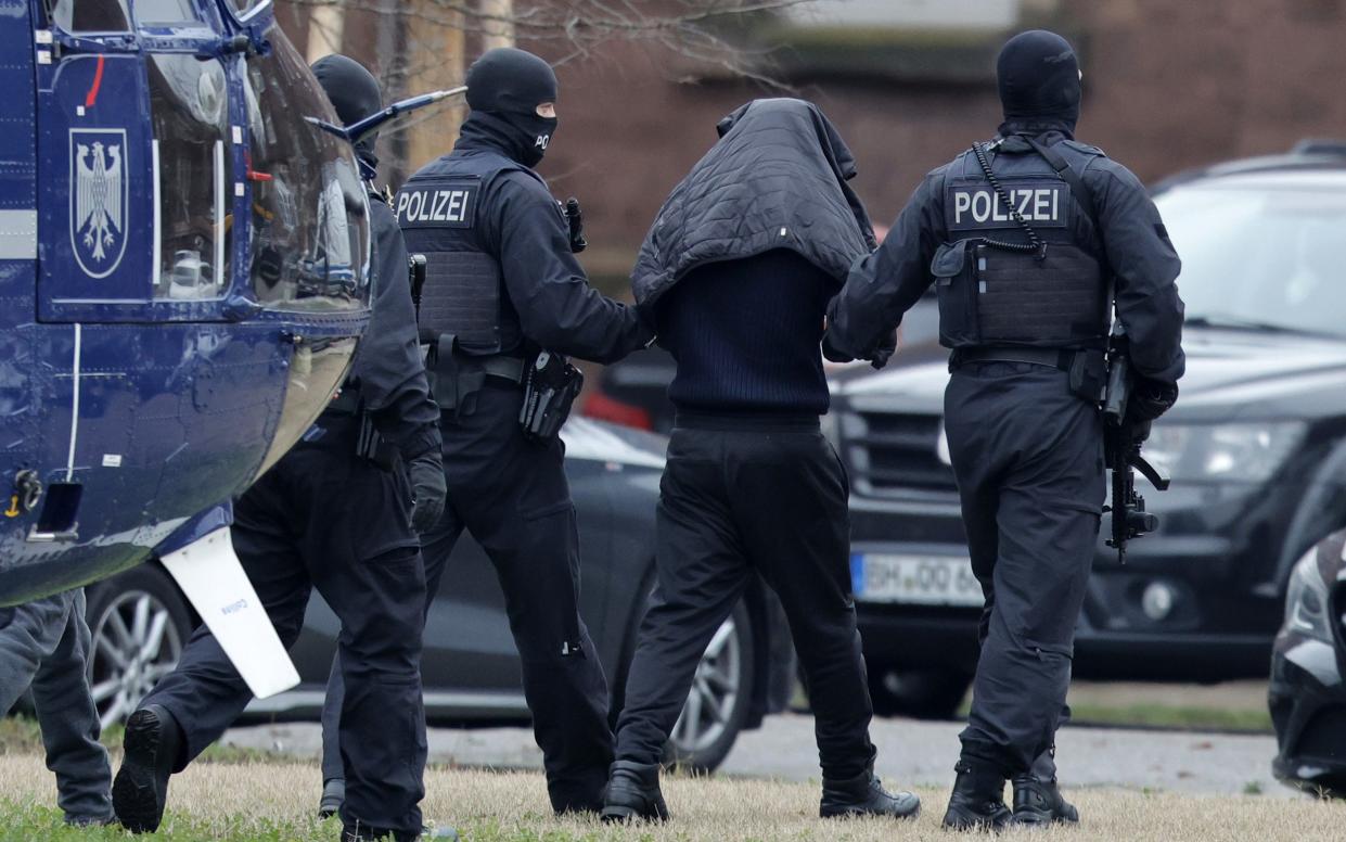 Hamas suspects are led from a helicopter ahead of their arraignment in a Karlsruhe court