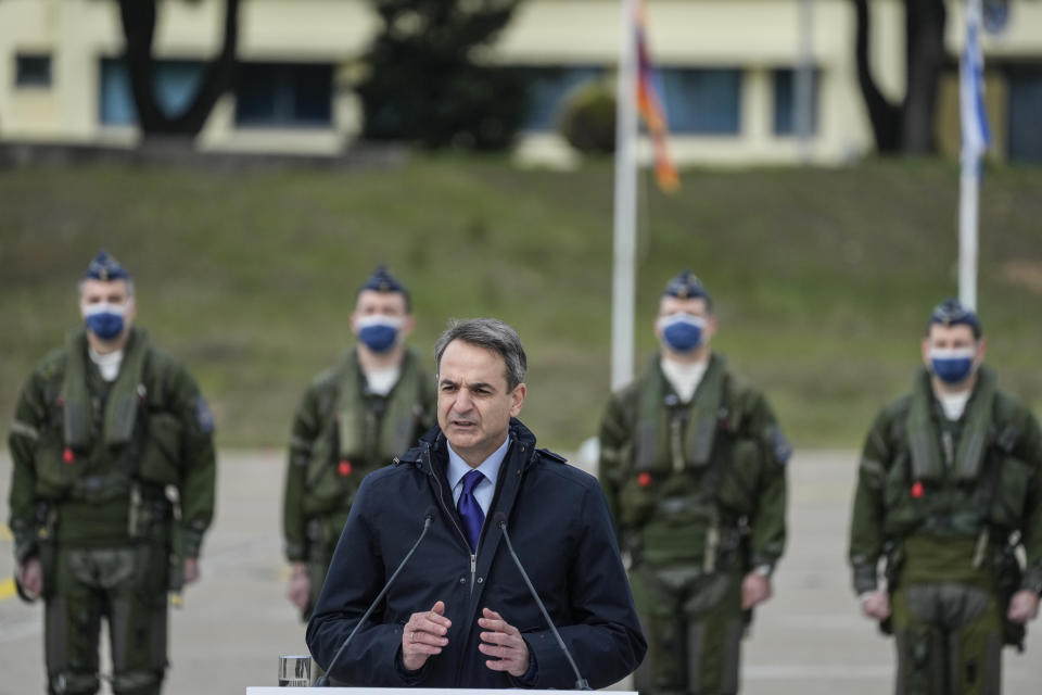 Greek Prime Minister Kyriakos Mitsotakis speaks in front of Greek airforce pilots during a hand over ceremony in Tanagra military air base, about 82 kilometres (51miles) north of Athens, Greece, on Wednesday, Jan. 19, 2022. Six advanced-tech Rafale jets bought from the French air force were handed over Wednesday to the Greek armed forces ‒ the first major delivery to result from multi-billion euro defense deals sealed with Paris last year. (AP Photo/Thanassis Stavrakis)