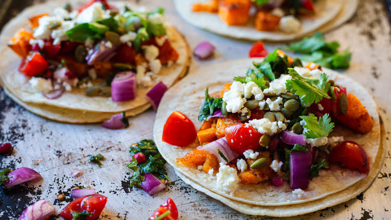 three tacos on baking sheet