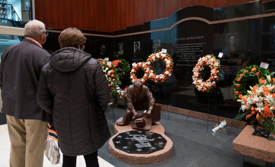 People visit the Remember the Ten memorial inside Gallagher-Iba Arena before last year's OSU men's college basketball game against Ole Miss.