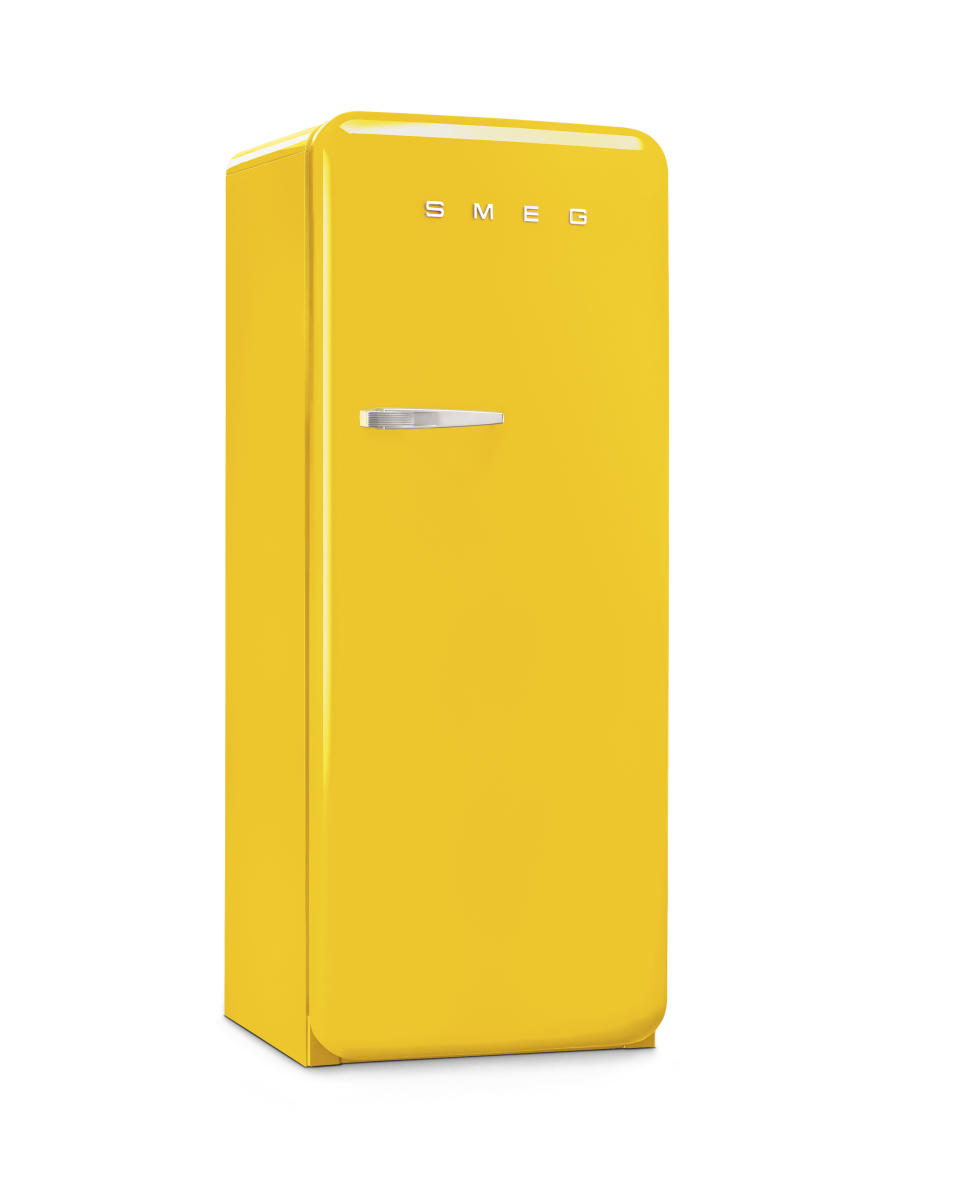 This photo provided by SMEG USA shows one of their yellow fridges. If you're keen to take a bigger leap into yellow beyond just paint or accessories, consider appliances. SMEG has a suite of stoves, range hoods and fridges in the hue; paired with neutral colors, stone and wood, the look is upbeat and uber cool. (SMEG USA via AP)