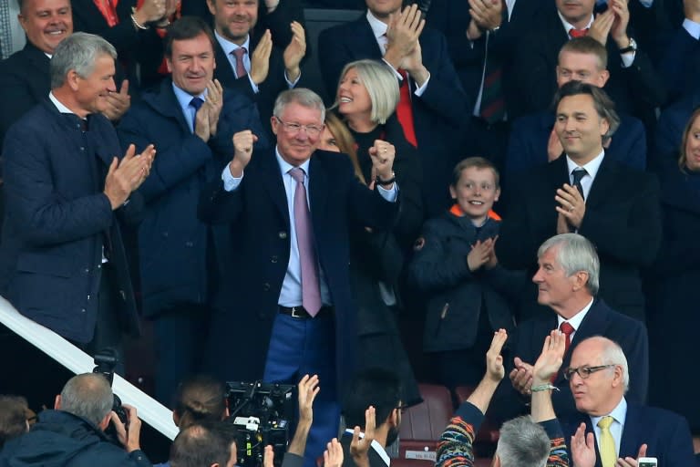 The boss is back: Alex Ferguson gestures to the Old Trafford crowd