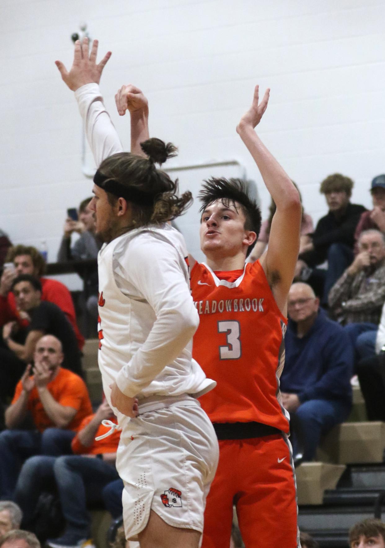 Meadowbrook's Jake Singleton follows through on his three-pointer against New Lexington that broke the Meadowbrook scoring record during regular season action. Singleton was tabbed the District 12 Division II boys player of the year.