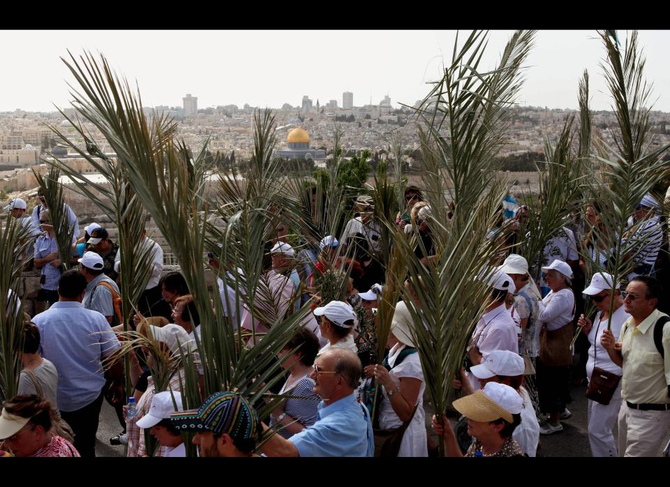 Chrisitian pilgrims carry palm branches during the Palm Sunday procession from Mt. Olives into Jerusalem's old city, marking the triumphant return of Jesus Christ to Jerusalem when a cheering crowd greeted him waving palm leaves the week before his death.&nbsp;