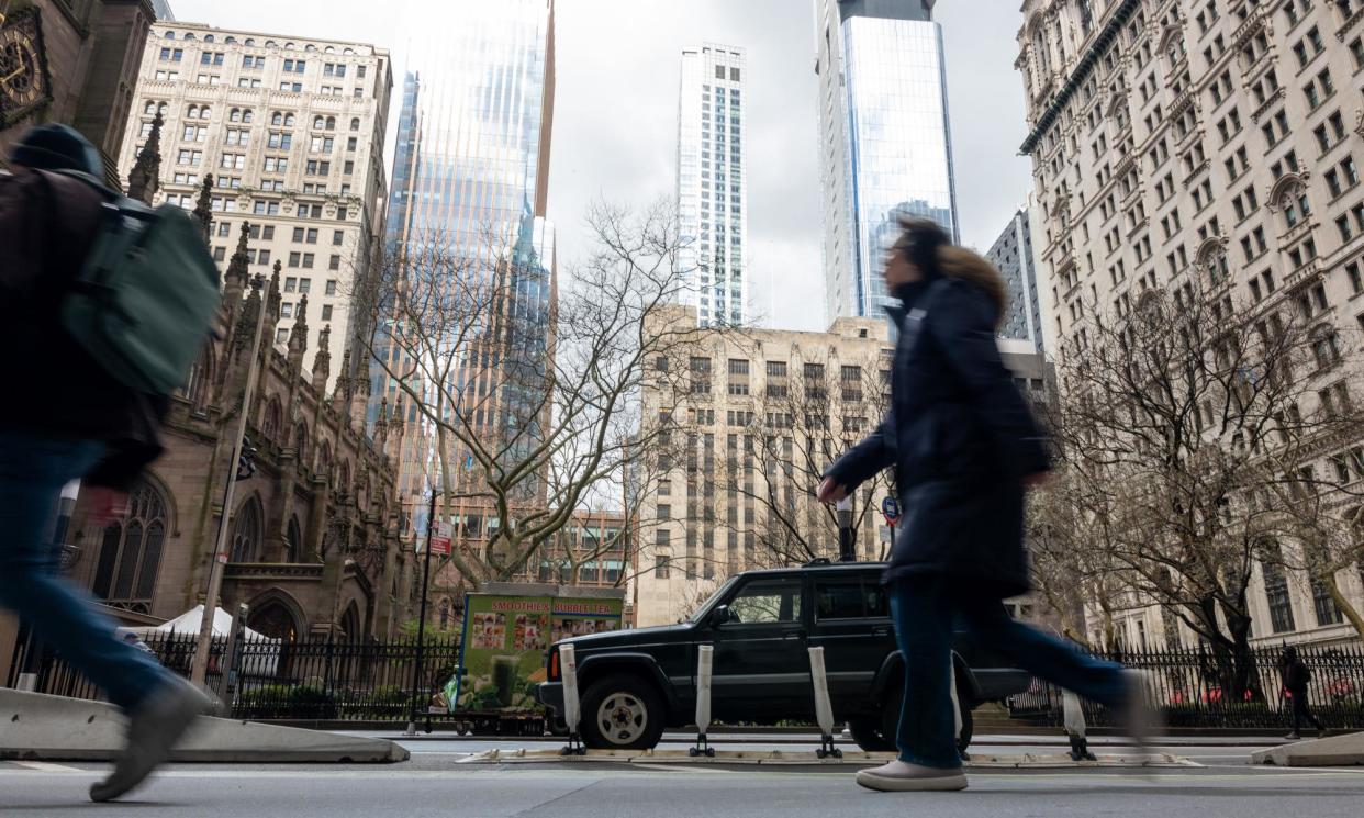 <span>People walk through lower Manhattan moments after New York City and elsewhere in the north-eastern US experienced a 4.8 magnitude earthquake on 5 April 2024.</span><span>Photograph: Spencer Platt/Getty Images</span>