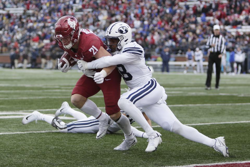 Washington State running back Max Borghi, left, tries to get away form BYU defensive back Kaleb Hayes during the second half of an NCAA college football game, Saturday, Oct. 23, 2021, in Pullman, Wash. | Young Kwak, Associated Press