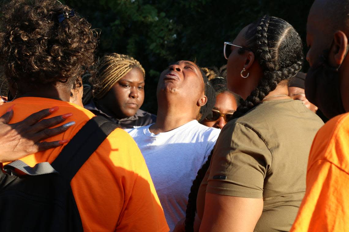 Community members gathered and prayed for Cynthia Smith (center) at a vigil Friday evening, July 7, in downtown Fort Worth. Her son, Billy Jaquan Smith, 21, was one of two men who were shot and killed by law enforcement officers early Wednesday.