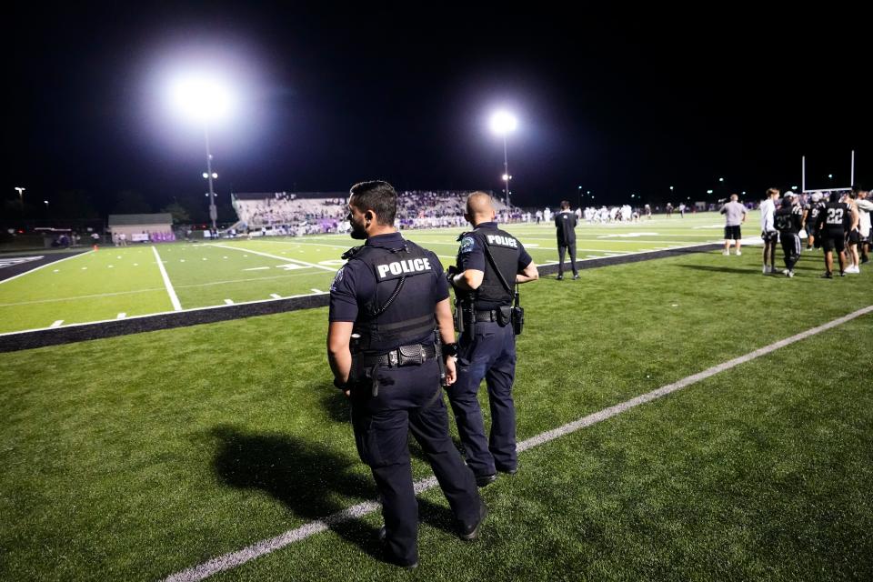 Police officers stand on the sideline during the high school football game between host Pickerington North and Pickerington Central on Friday.