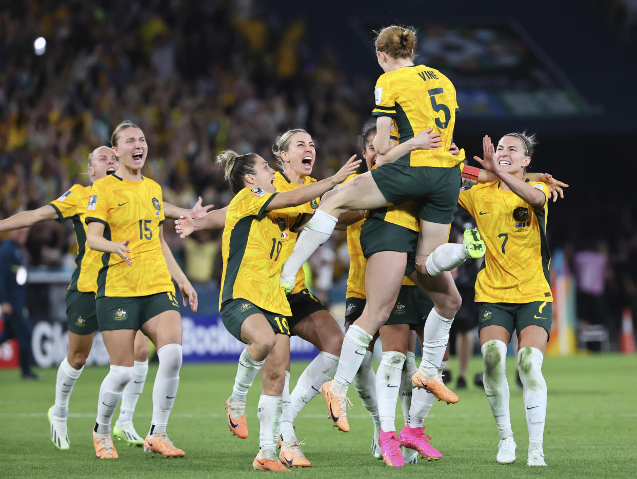 Australia players celebrate after winning the Women's World Cup quarterfinal soccer match between Australia and France in Brisbane, Australia, Saturday, Aug. 12, 2023. (AP Photo/Tertius Pickard)