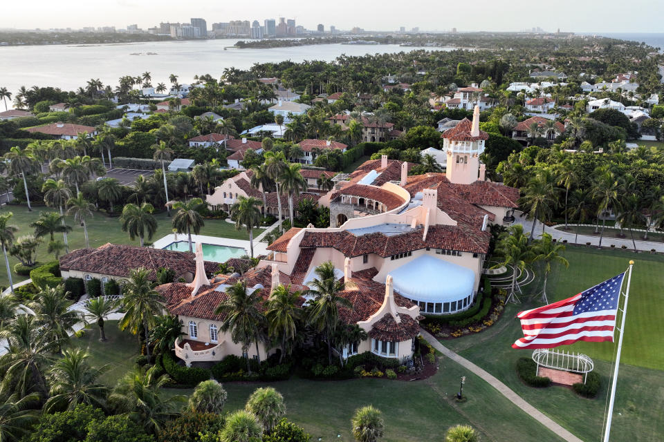 FILE - This is an aerial view of former President Donald Trump's Mar-a-Lago estate, Aug. 10, 2022, in Palm Beach, Fla. An employee of Donald Trump's Mar-a-Lago estate, Carlos De Oliveira, is expected to make his first court appearance Monday, July 31, on charges accusing him of scheming with the former president to hide security footage from investigators probing Trump's hoarding of classified documents. (AP Photo/Steve Helber, File)