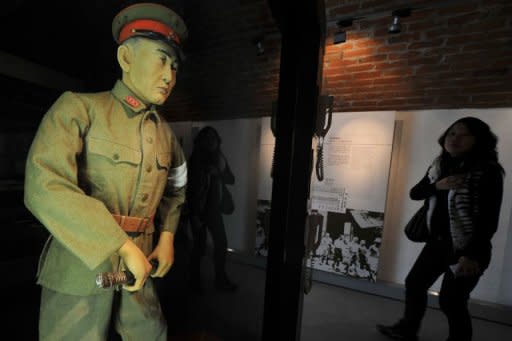 A woman reacts when she sees a scale model of a Japanese Kempeitai (military police) at the "Japanese Occupation" exhibition of the Hong Kong Museum of Coastal Defence. Christmas is a day of sombre remembrance for veterans of the World War II battle of Hong Kong, which fell to the Japanese on this day 70 years ago after 18 days of desperate fighting