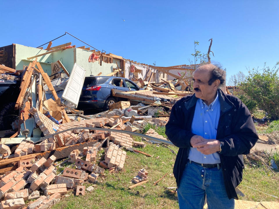 Masoud Shahed-Ghaznavi stands in front of his home that was destroyed by Friday's tornado in Little Rock, Ark., Saturday, April 1, 2023. Unrelenting tornadoes that tore through parts of the South and Midwest that shredded homes and shopping centers. (AP Photo/Andrew DeMillo)