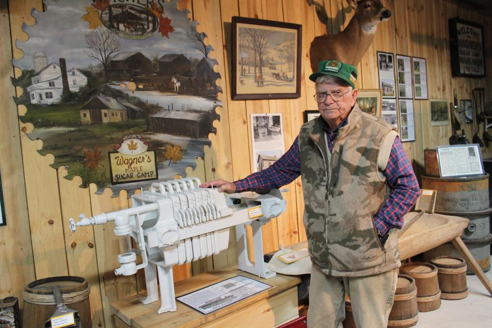 Ron Brenneman, a retired maple producer, stands by a press he donated to and is now on display at Wagner's Sugar Camp near Salisbury in their artifacts display room. Brenneman was helping out at Wagner's for the maple tour on Saturday.
