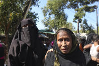 Rohingya refugees who are being moved to an island called ‘Bhasan Char’ gather outside a transit area where they are temporally housed in Ukhiya, Bangladesh, Thursday, Dec.3, 2020. (AP Photo/ Shafiqur Rahman)