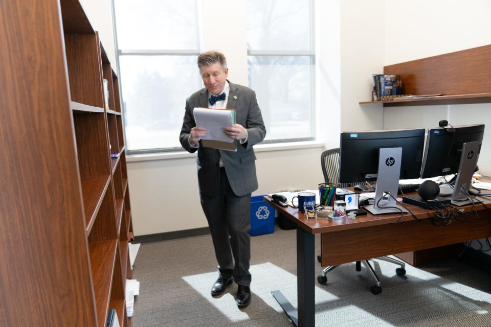 Washburn Law dean Jeffrey Jackson gathers his materials to coach his constitutional moot court team Tuesday afternoon from his office.