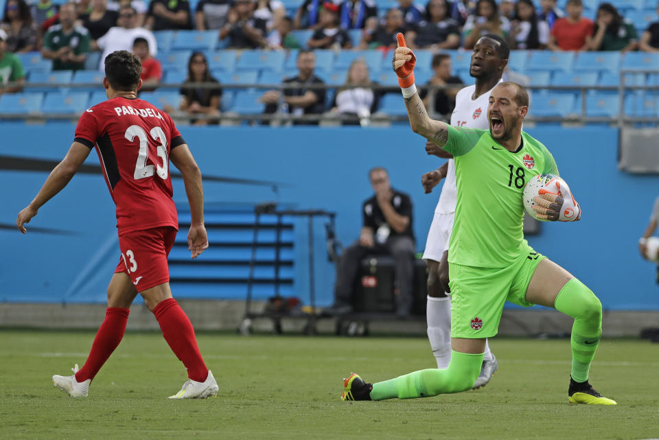 Canada's Milan Borjan (18) reacts after a save against Cuba's Luis Paradela (23) during the first half of a CONCACAF Golf Cup soccer match in Charlotte, N.C., Sunday, June 23, 2019. (AP Photo/Chuck Burton)