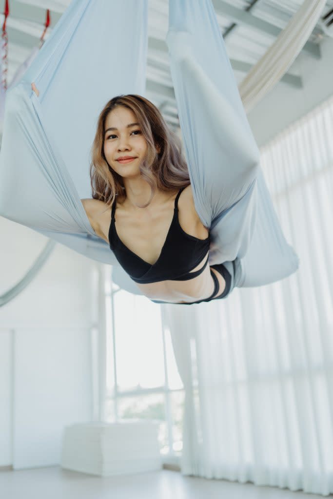 Woman wrapped in silks during aerial yoga hobby