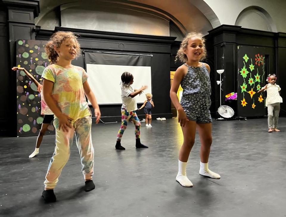 Children at the EN-RICH-MENT Fine Arts Academy's summer camp practice a dance routine.