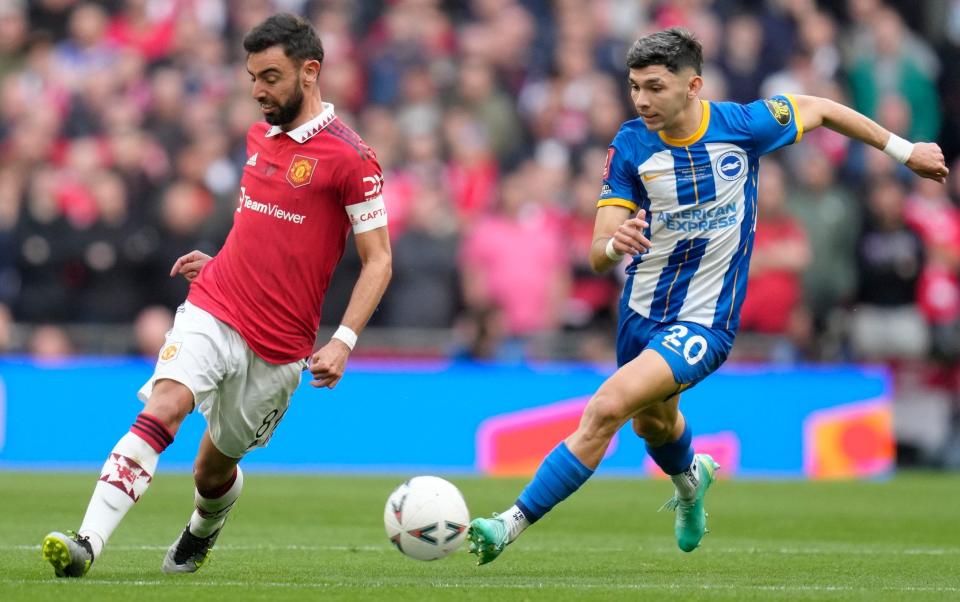 Manchester United's Bruno Fernandes, left, is challenged by Brighton's Julio Enciso - AP Photo/Kirsty Wigglesworth