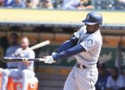 Aug 15, 2018; Oakland, CA, USA; Seattle Mariners second baseman Dee Gordon (9) hits a two run home run against the Oakland Athletics during the twelfth inning at Oakland Coliseum. Mandatory Credit: Kelley L Cox-USA TODAY Sports