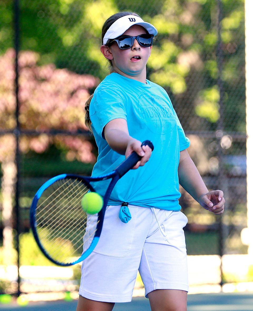 Gwenyth Miller returns a volley during her match in the Brookside junior tennis program championships on Thursday, June 30, 2022. TOM E. PUSKAR/ASHLAND TIMES-GAZETTE