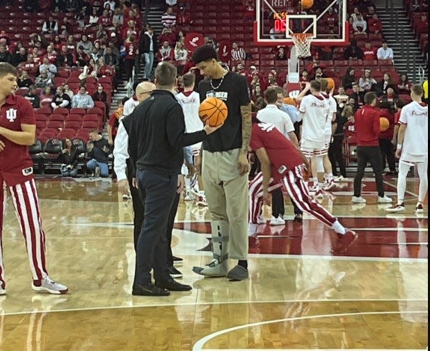 Kel'el Ware (center) wears a boot on his foot ahead of IU's game at Wisconsin on Friday night.