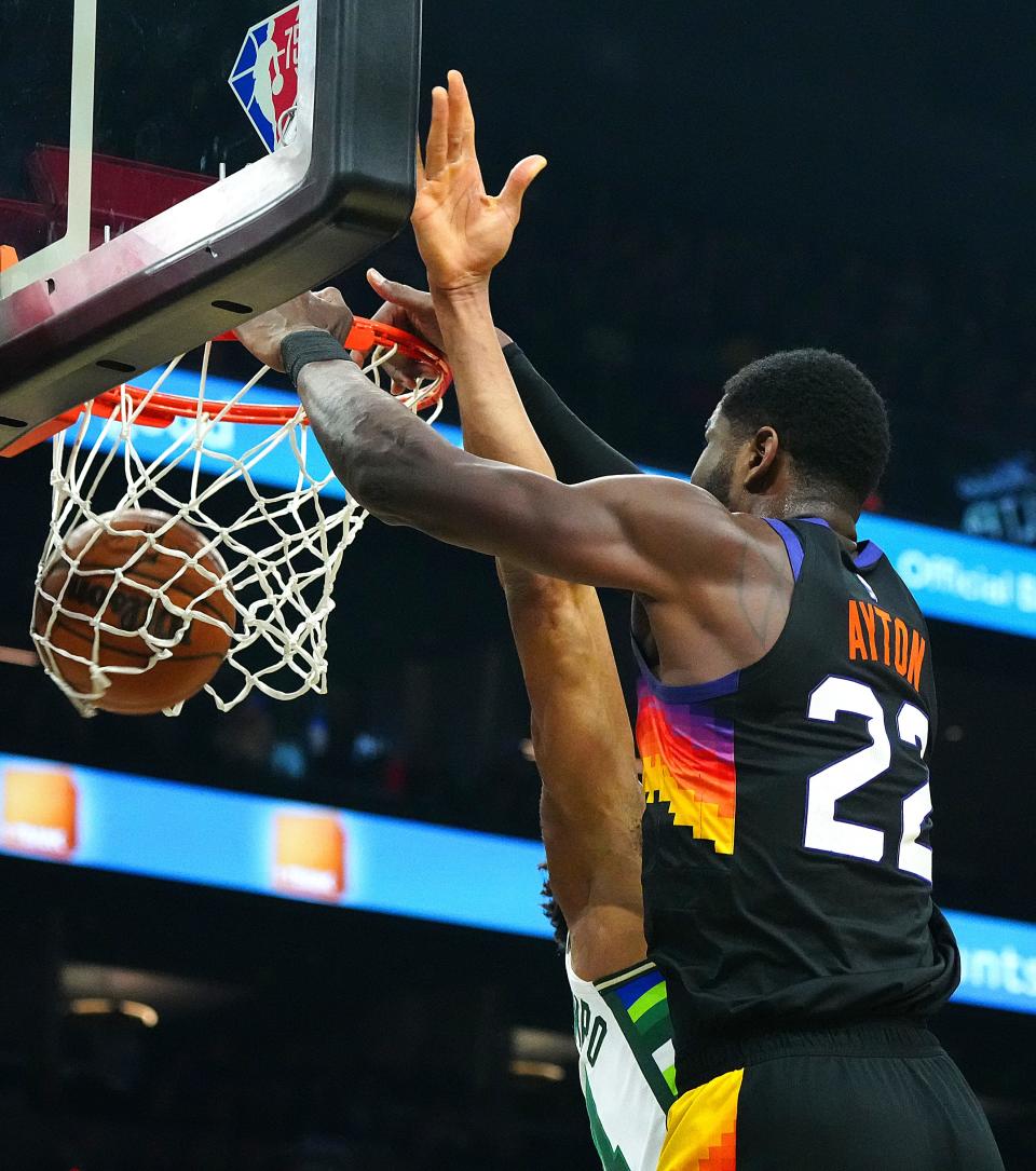 Feb 10, 2022; Phoenix, Arizona, USA; Suns' Deandre Ayton (22) dunks against Bucks' Giannis Antetokounmpo (34) during the second half at Footprint Center.