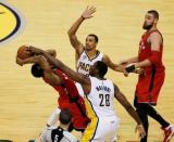 Apr 29, 2016; Indianapolis, IN, USA; Toronto Raptors guard Kyle Lowry (7) controls the ball as Indiana Pacers guard George Hill (3) and center Ian Mahini (28) defend during the first quarter in game six of the first round of the 2016 NBA Playoffs at Bankers Life Fieldhouse. Mandatory Credit: Brian Spurlock-USA TODAY Sports