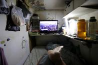 A TV screen showing a view of Hong Kong is seen inside Leung Hon-Kee's 3 square metre subdivided residential unit, known as a "coffin home", following the outbreak of the new coronavirus, in Hong Kong