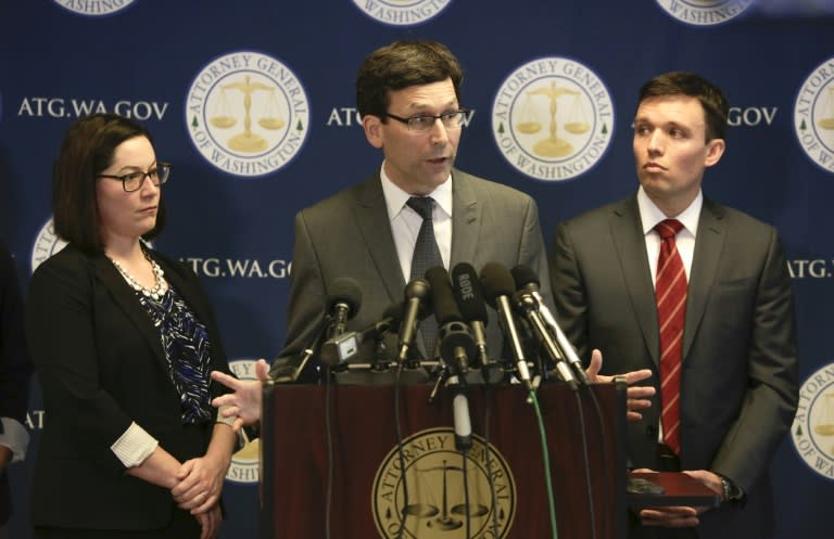 Washington State Attorney General Bob Ferguson (C) gives a press conference asking a federal judge to block US President Donald Trump's revised travel ban by affirming an order blocking the first ban, in Seattle, Washington on March 9, 2017