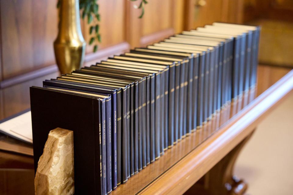A photograph of 35 volumes of President Russell M. Nelson’s collected operative records and scientific publications.