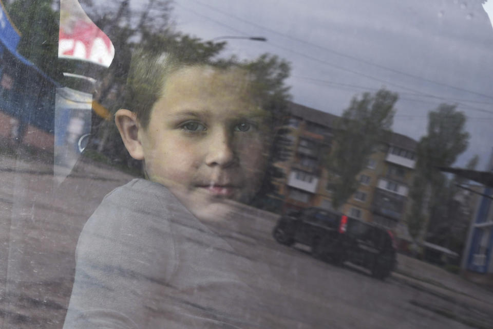 A boy looks out of a bus during an evacuation of civilians in Kramatorsk, Ukraine, Saturday, April 30, 2022. (AP Photo/Andriy Andriyenko)