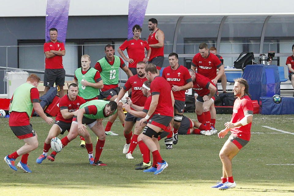 FILE - In this Sept. 16, 2019, file photo, Wales' rugby team players work out in front of the spectators in Kitakyushu, western Japan, ahead of the Rugby World Cup in Japan. Wales assistant coach Rob Howley has been sent home from the Rugby World Cup in Japan over a potential breach of betting rules. (Kyodo News via AP