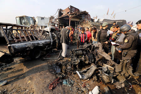 Iraqi policemen and people inspect the site of a car bomb attack at a vegetable market in eastern Baghdad, Iraq January 8, 2017. REUTERS/Wissm al-Okili