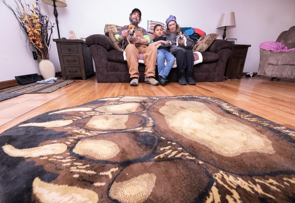 Chandra Potschner, her husband William "Toby" Potschner, and their grandson Keaton Cox, 8, along with dogs Ezra and Ruby, sit in the living room of the home they recently purchased in Stark County after Chandra won $500,000 with an Ohio Lottery scratch-off game last year. The couple also will appear in a future episode of HGTV's "My Lottery Dream Home."