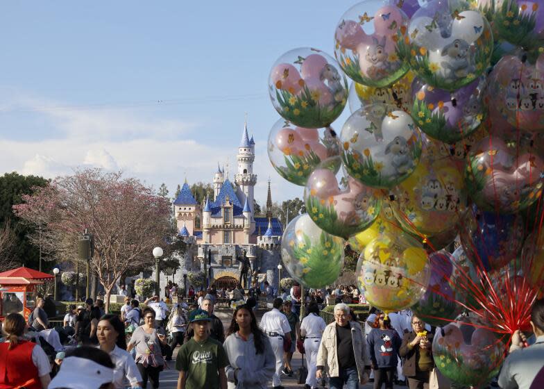 Anaheim, CA - March 11: Visitors walk down Main Street, U.S.A. at Disneyland Monday, March 11, 2024. (Allen J. Schaben / Los Angeles Times)