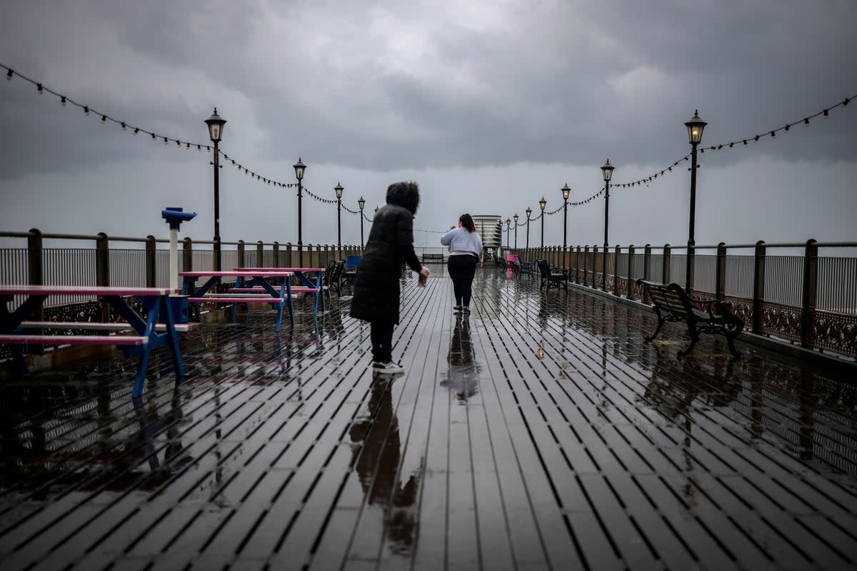 Holidaymakers brave a downpour on Skegness Pier (Getty Images)