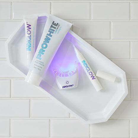 The bright purple light gently but effectively whitens your smile. (Photo: HSN)