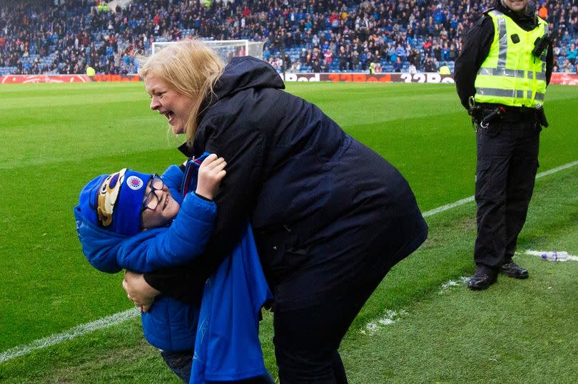 Connor Goldson gives young Rangers fan Iain Norrie (8) a signed shirt at half time during the Scottish Premiership match at Ibrox Stadium, Glasgow.