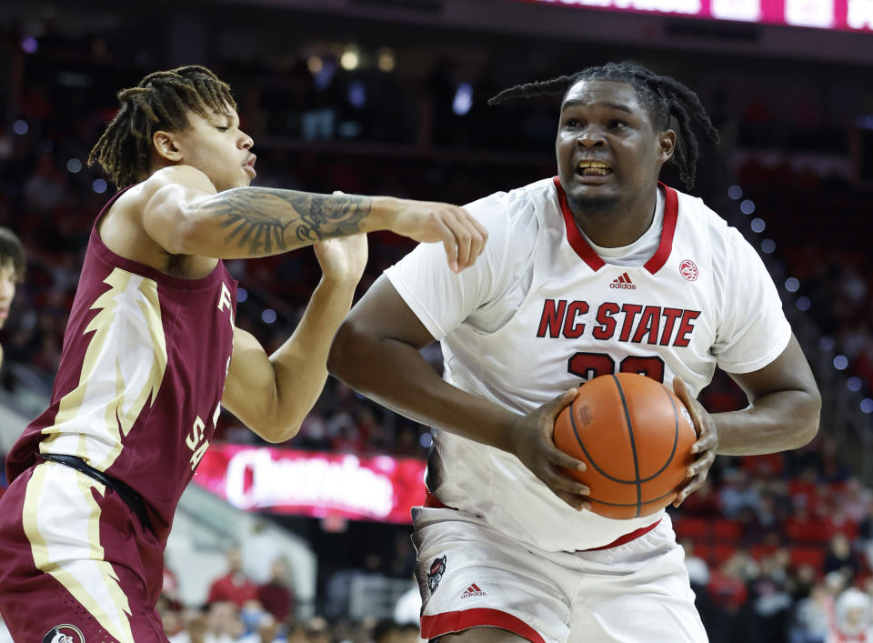 Florida State's Cam Corhen (3) defends North Carolina State's D.J. Burns Jr. (30) during the first half of an NCAA college basketball game, Wednesday, Feb. 1, 2023 in Raleigh, N.C. (Ethan Hyman/The News & Observer via AP)