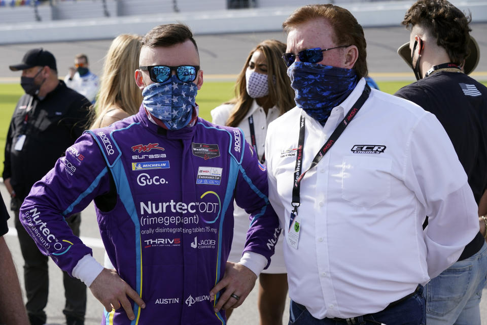 Austin Dillon, left, talks with his grandfather Richard Childress on pit road before the start of the Rolex 24 hour auto race at Daytona International Speedway, Saturday, Jan. 30, 2021, in Daytona Beach, Fla. (AP Photo/John Raoux)