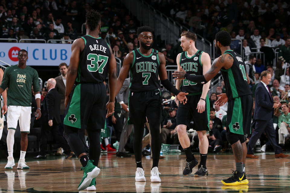 MILWAUKEE, WI – APRIL 28: Jaylen Brown #7, and Kyrie Irving #11 of the Boston Celtics exchange hi-fives against the Milwaukee Bucks during Game One of the Eastern Conference Semi-Finals of the 2019 NBA Playoffs on April 28, 2019 at the Fiserv Forum in Milwaukee, Wisconsin. NOTE TO USER: User expressly acknowledges and agrees that, by downloading and or using this photograph, user is consenting to the terms and conditions of the Getty Images License Agreement. Mandatory Copyright Notice: Copyright 2019 NBAE (Photo by Gary Dineen/NBAE via Getty Images)