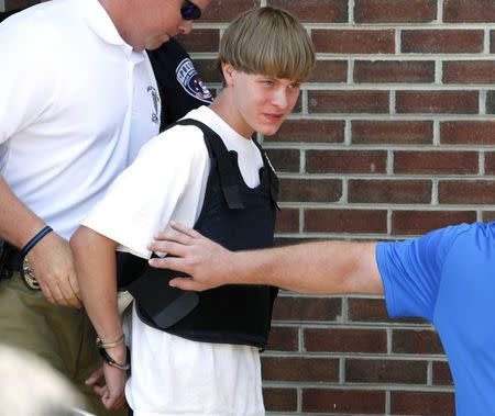 Police lead suspected shooter Dylann Roof into the courthouse in Shelby, North Carolina, June 18, 2015. REUTERS/Jason Miczek