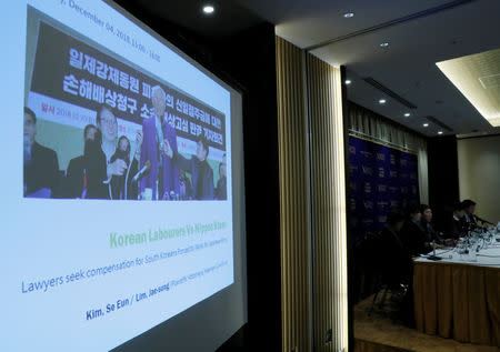 FILE PHOTO: A projection shows an image of a plaintiff who was forced to work for Japanese firms during World War Two and seeks compensation during a news conference in Tokyo, Japan, December 4, 2018. REUTERS/Kim Kyung-Hoon/File photo